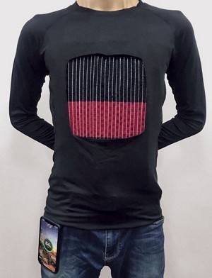 A man wearing a textile battery integrated into a shirt that recharges a cell phone in 40 minutes 