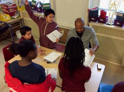 Jonté Lee working on paperwork with students